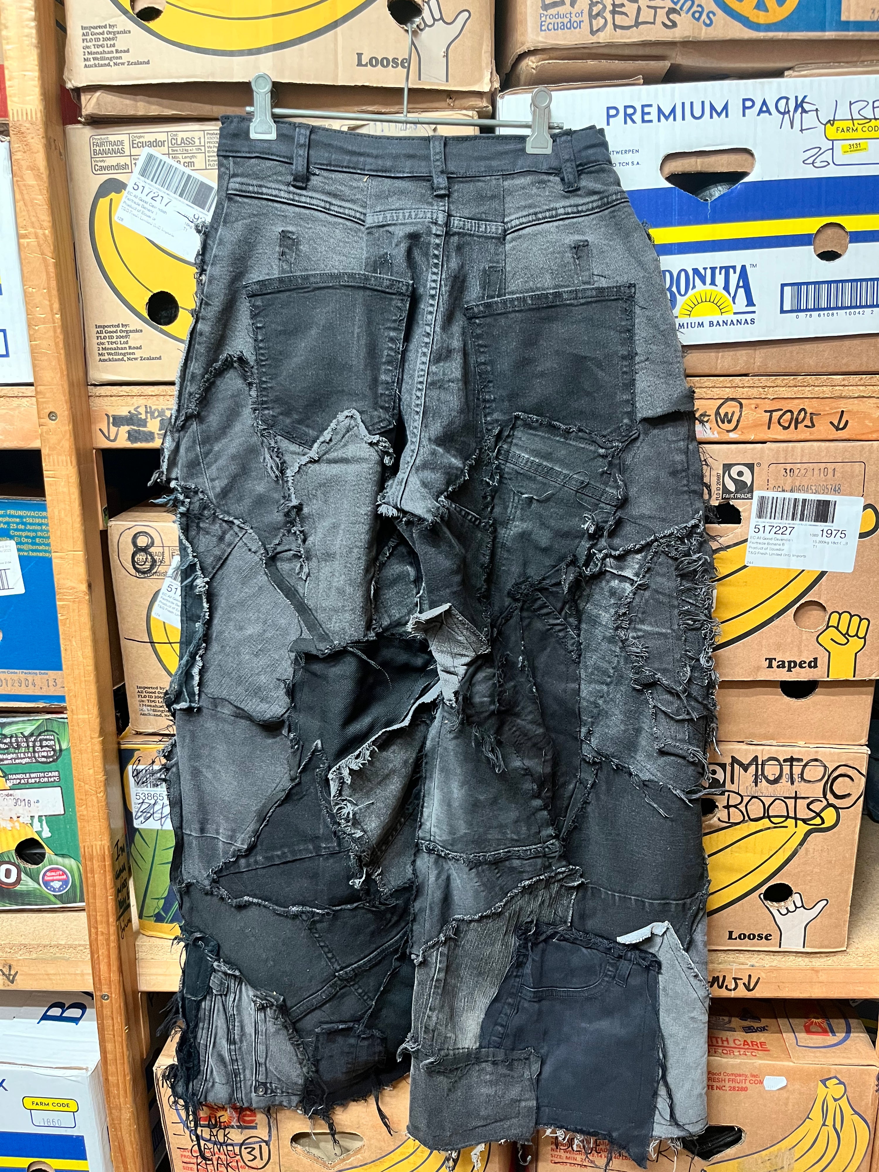 1-of-1 custom deconstructed black and grey denim patchwork wide leg pants.