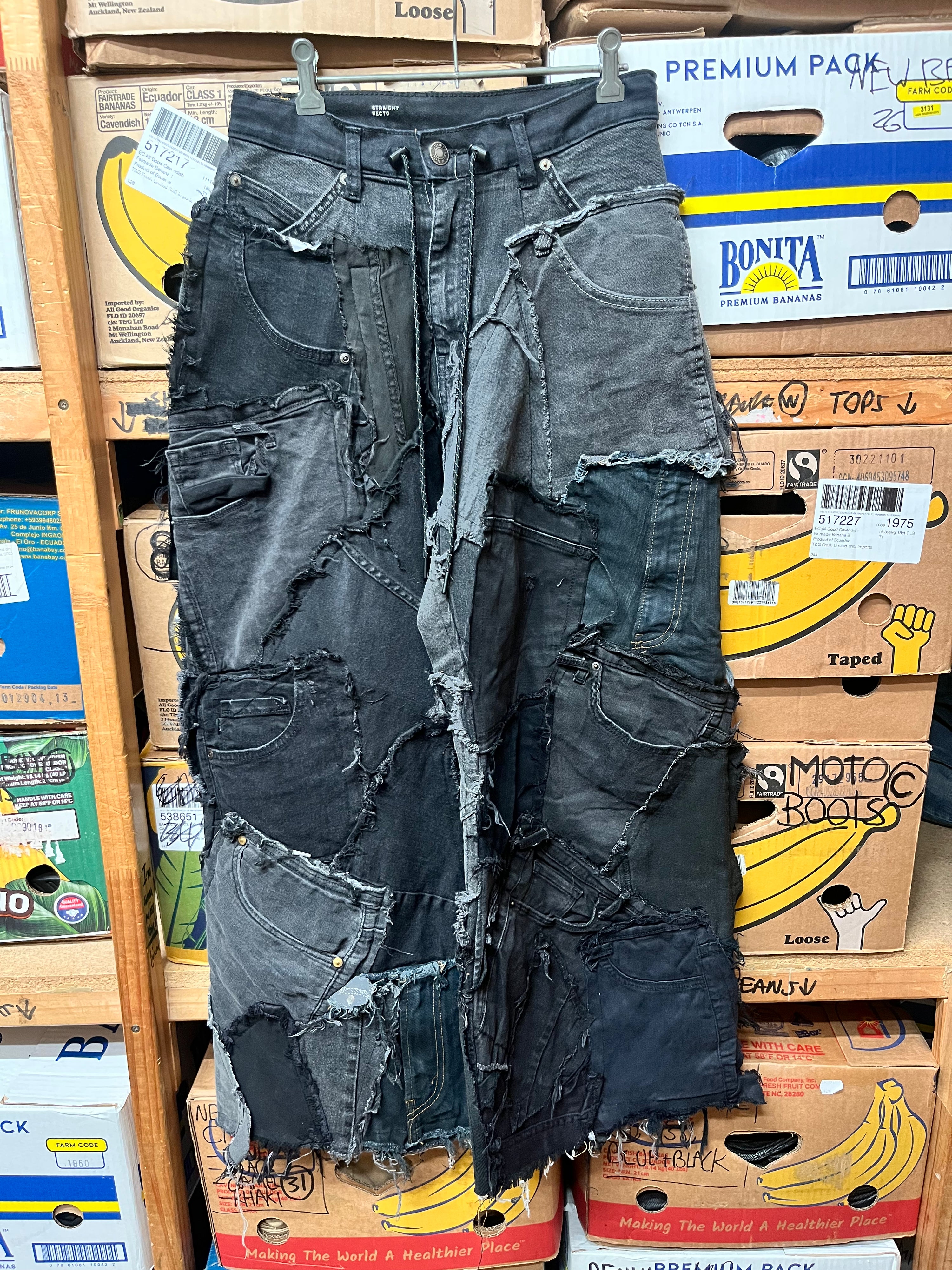 1-of-1 custom deconstructed black and grey denim patchwork wide leg pants.